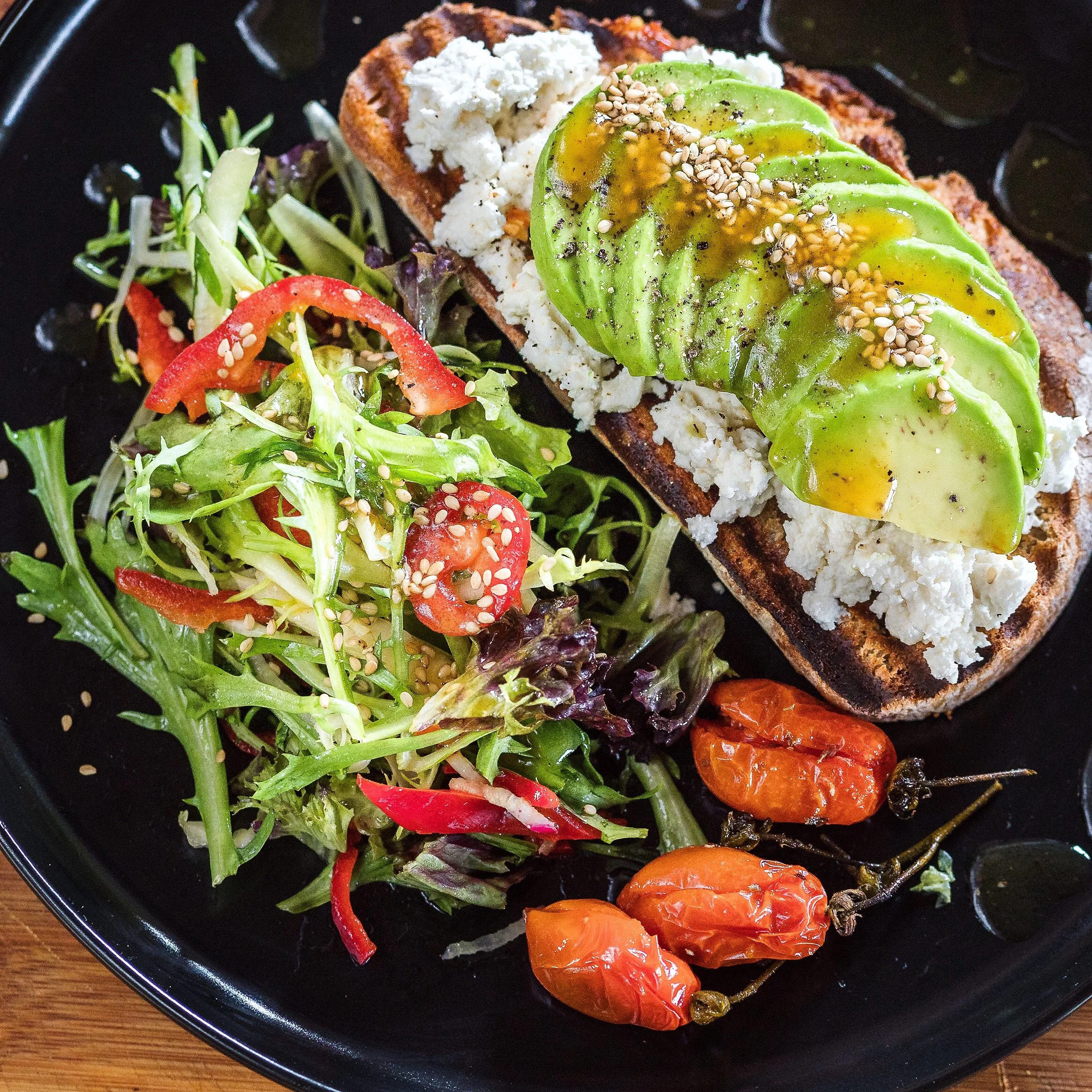 Karma Oia menu highlighting clearly labeled vegan and vegetarian dishes and gluten‑free choices for plant‑based travelers in Santorini.