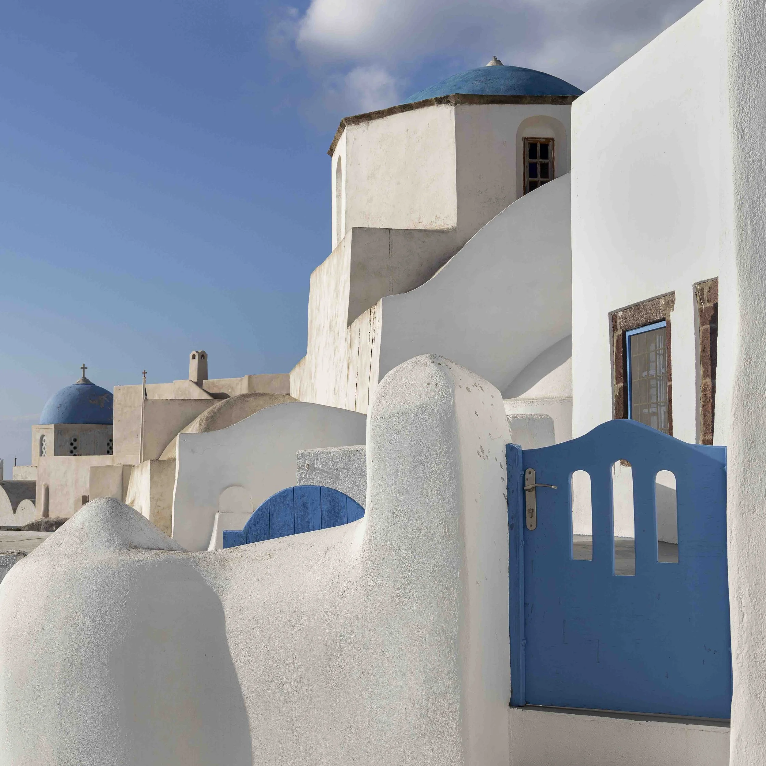 Pyrgos castle and winding streets portrait combining historic architecture and candid moments for timeless wedding photos.