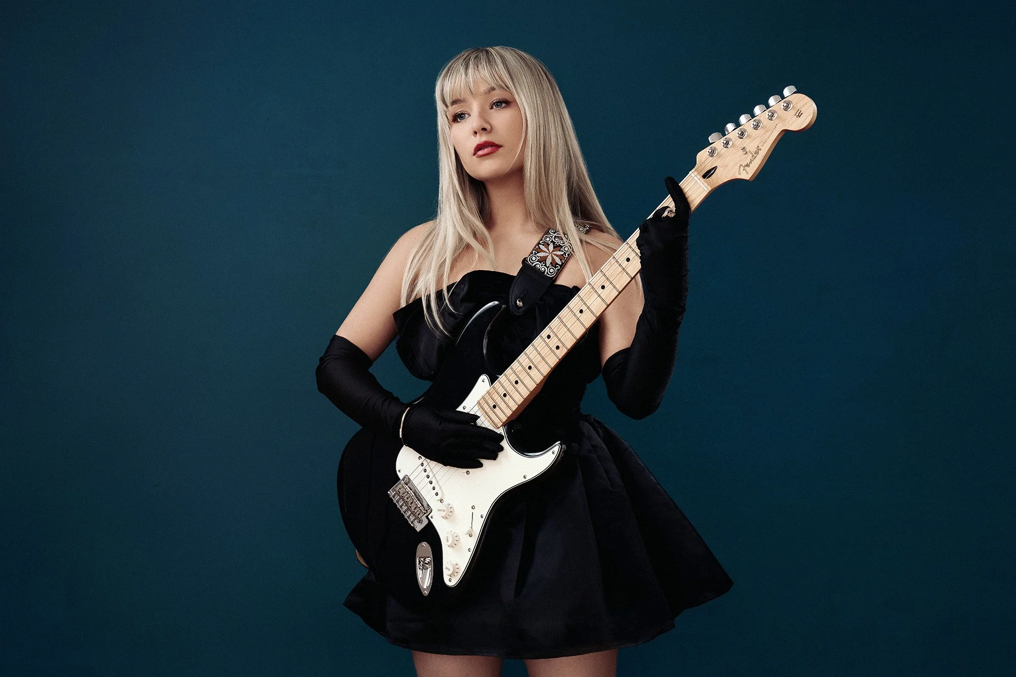 studio photo of singer Connie Talbot holding her Fender electric guitar