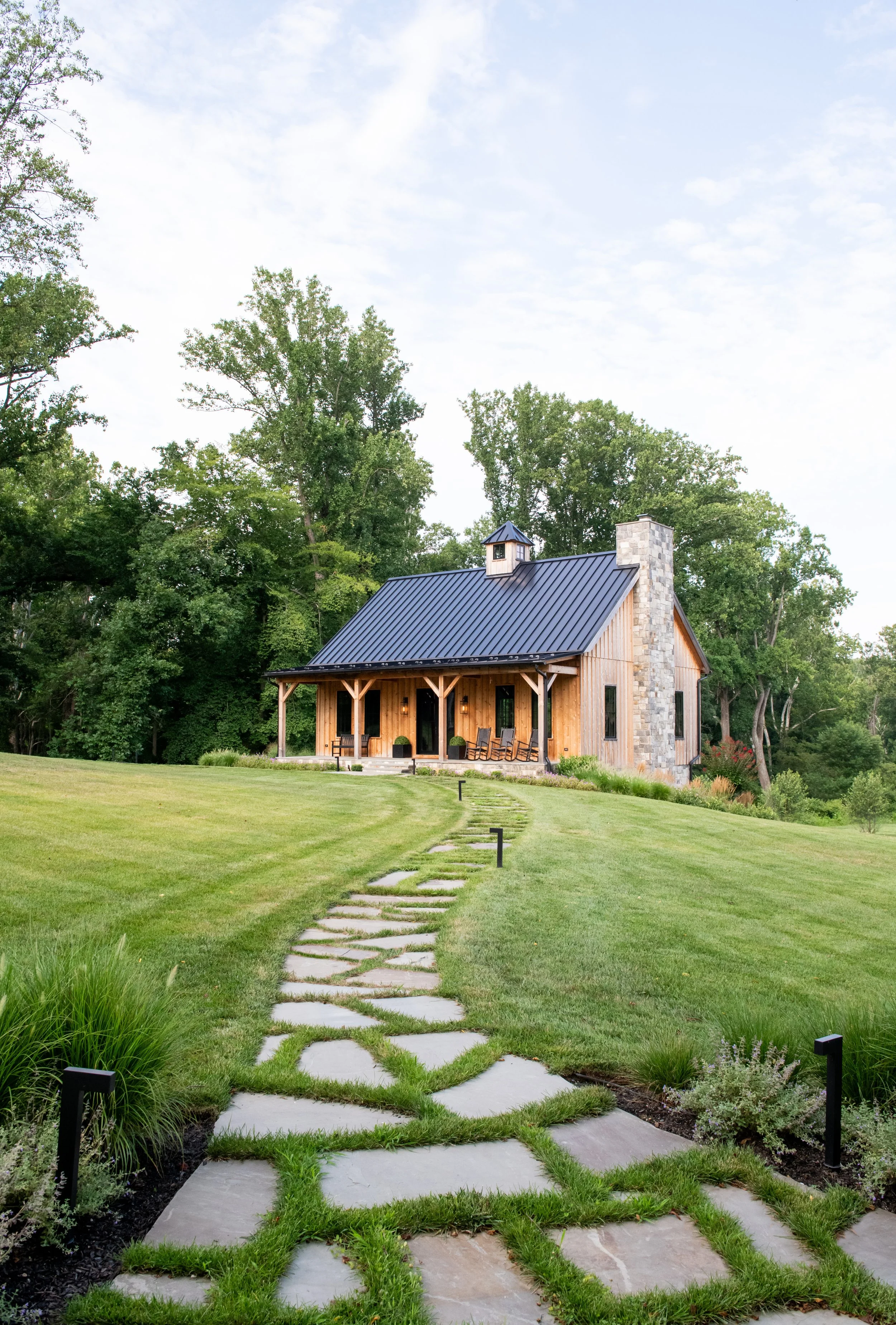 Party barn with rustic wood beams designed for entertaining.  Landscape architecture by FORM Garden Design.