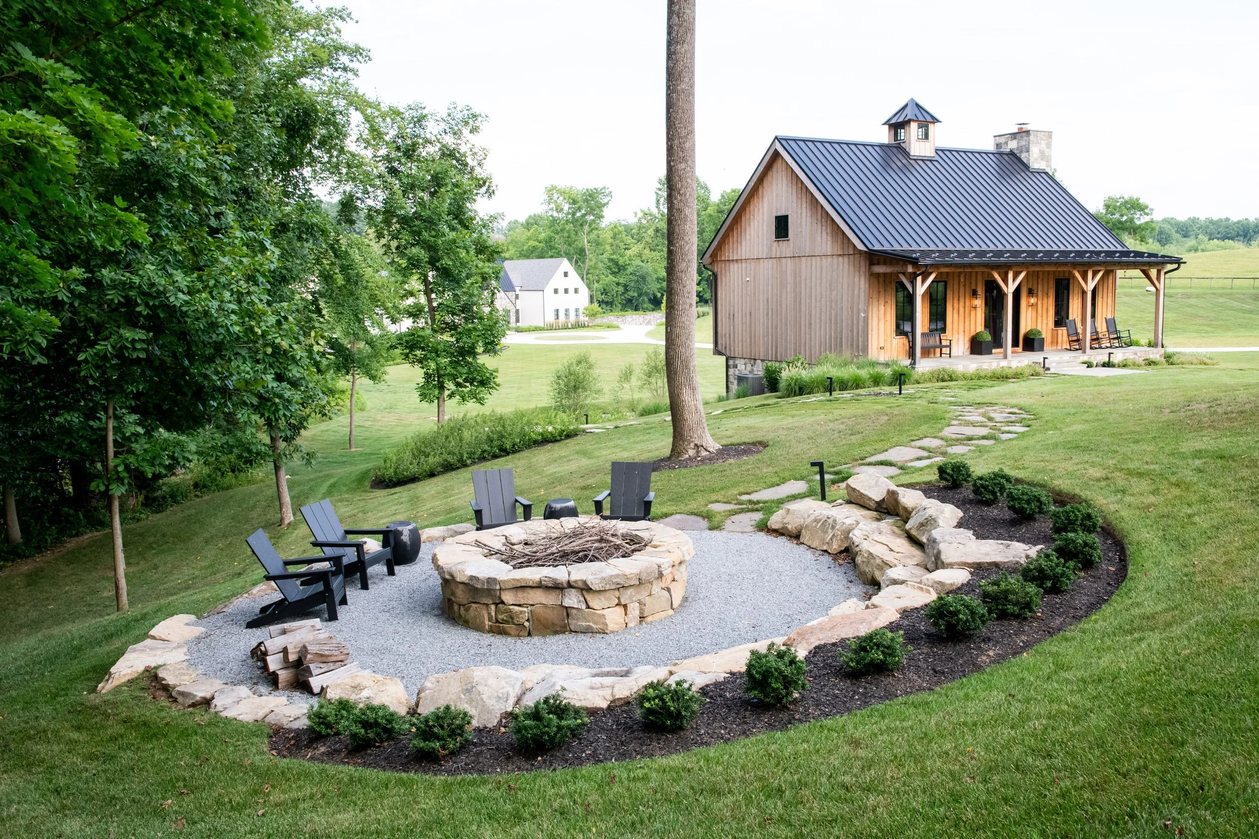 Party barn fire pit for enjoying cool nights outside with friends.  Designed by landscape architects, FORM Garden Design.