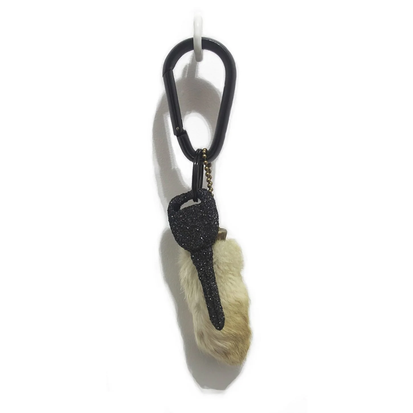 Fumbling at the Wheel. found rabbit foot charm circa 1980, black carabiner, incinerated VHS cassettes: Halloween 2 (1981), Friday the 13th: Part 2 (1981), Alone in the Dark (1982), Hell Night (1982), Leprechaun (1993), Scream (1996), Urban Legend (19