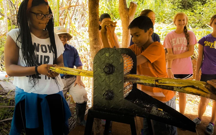 Pressing sugarcane during a traditional farm visit, Costa Rica