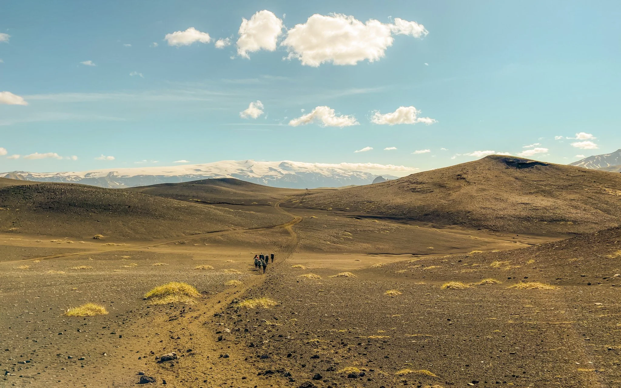 RLT travelers backpacking into a mountain valley