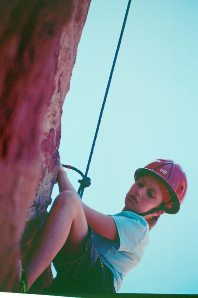 A student rock climbing during leader training