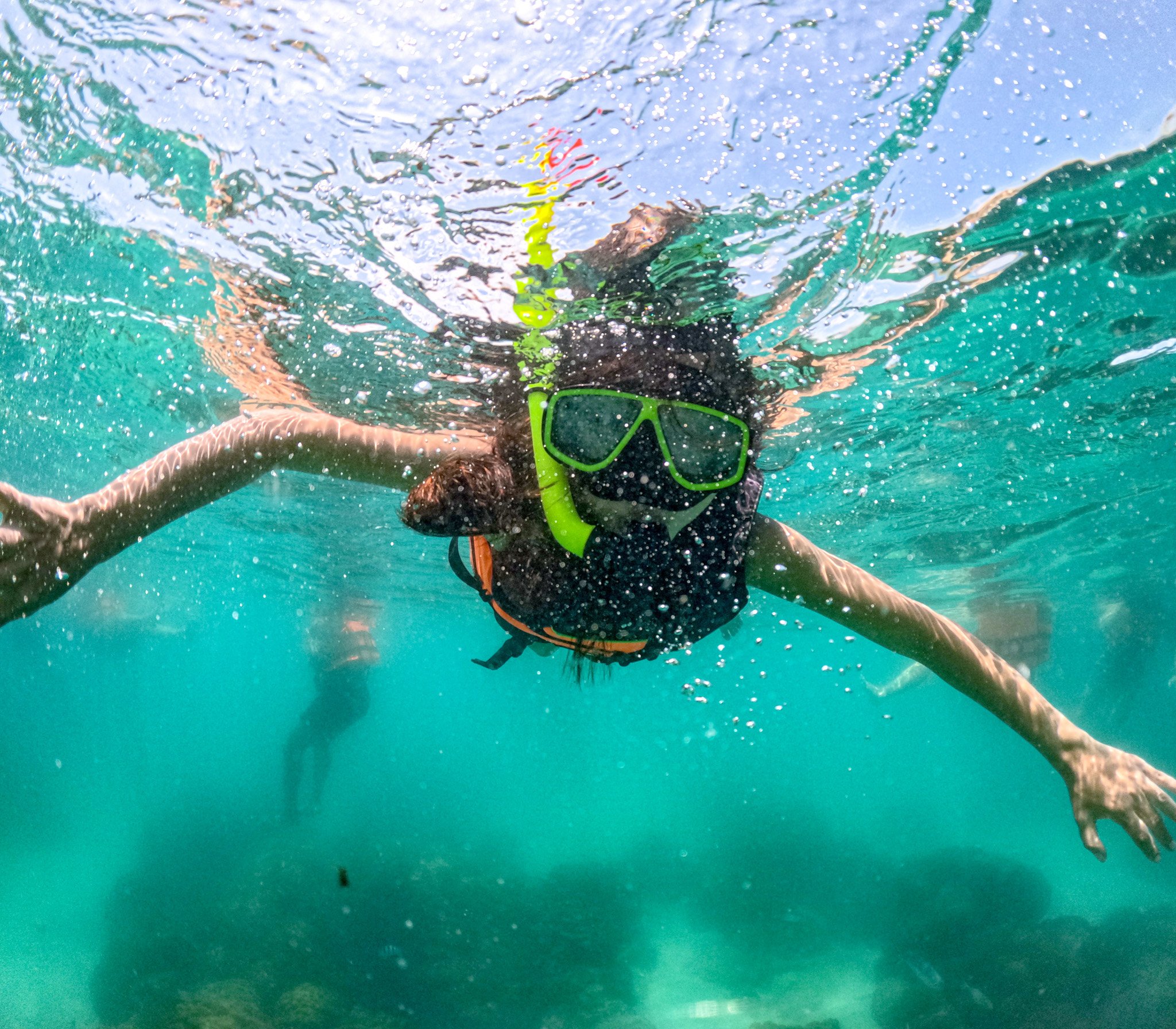 A traveler snorkeling in open water