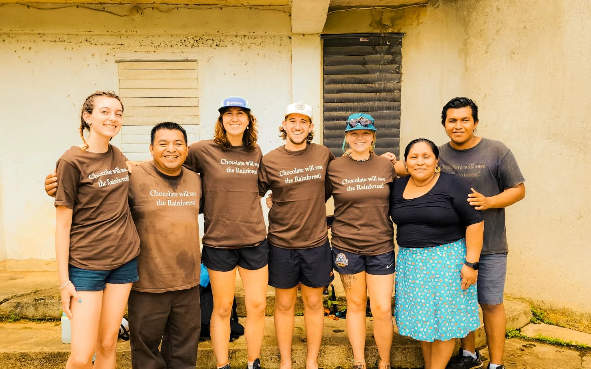 RLT teens standing with local community leaders in Costa Rica, smiling after a day of service work.