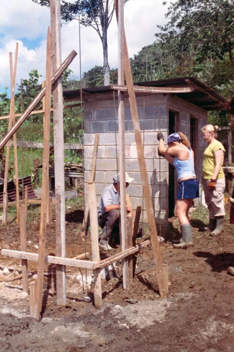 Travelers helping build a structure