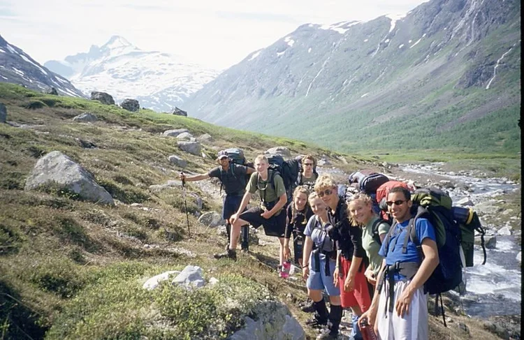 Group trekking through a mountain valley