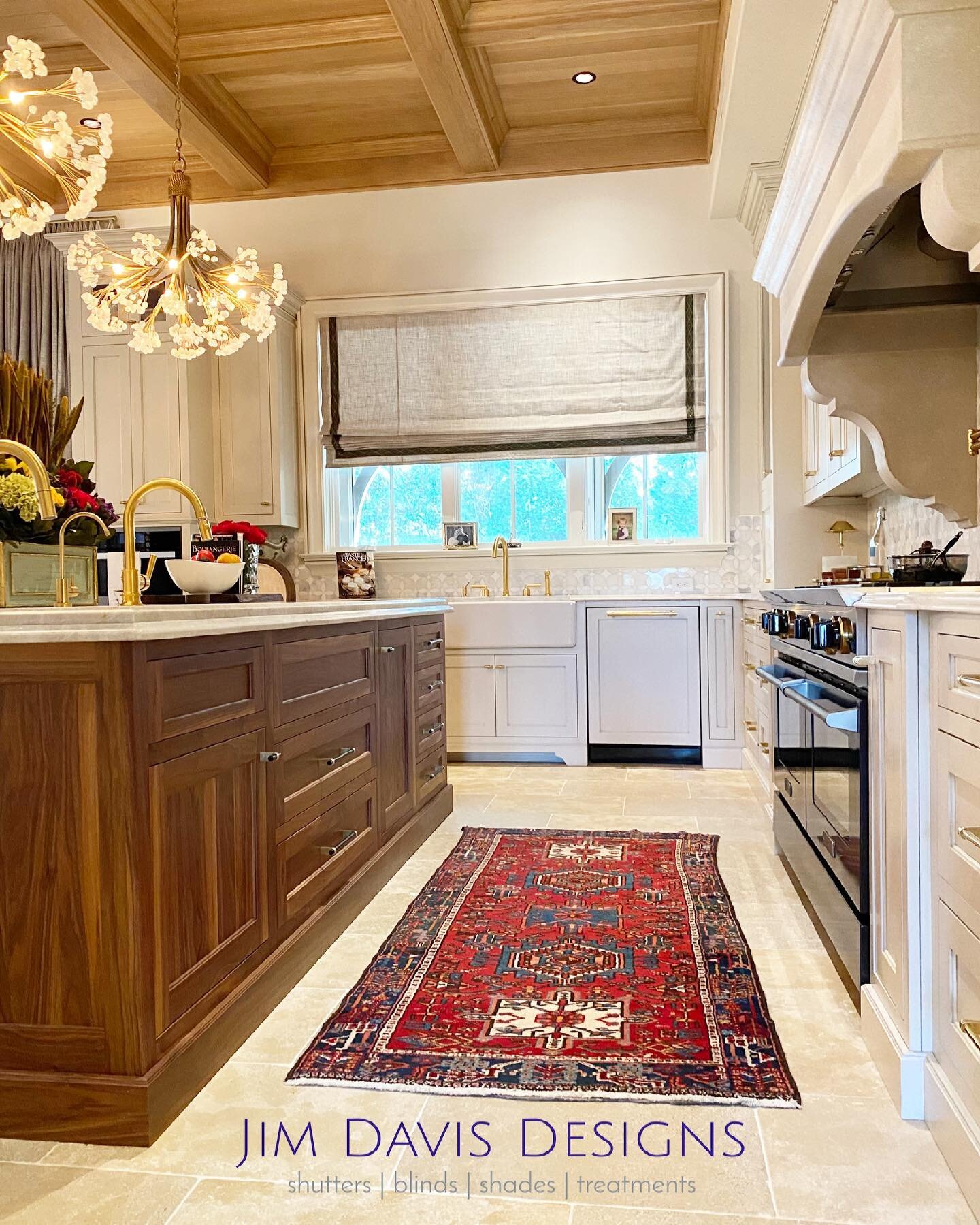Lovely roman shade for this kitchen window detailed with a raised unsent velvet edge accent tape.