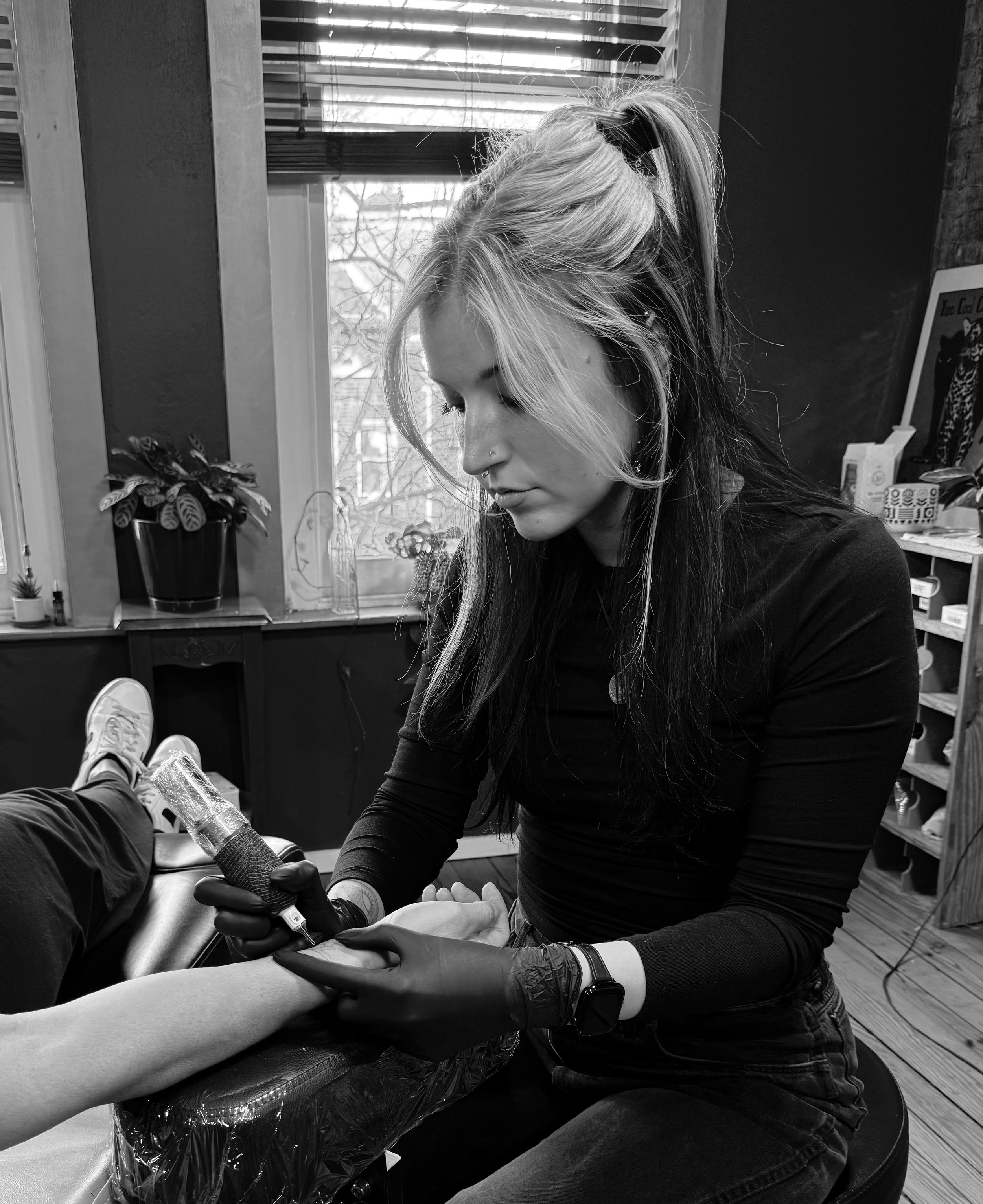 Livia Beck tattoo artist working on a client's arm