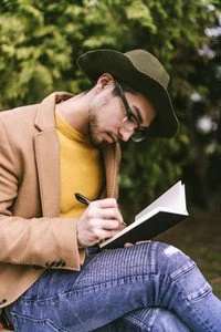 storyblocks-man-sitting-outside-and-writing-in-journal_HhszNQ3Fv_thumb.jpg