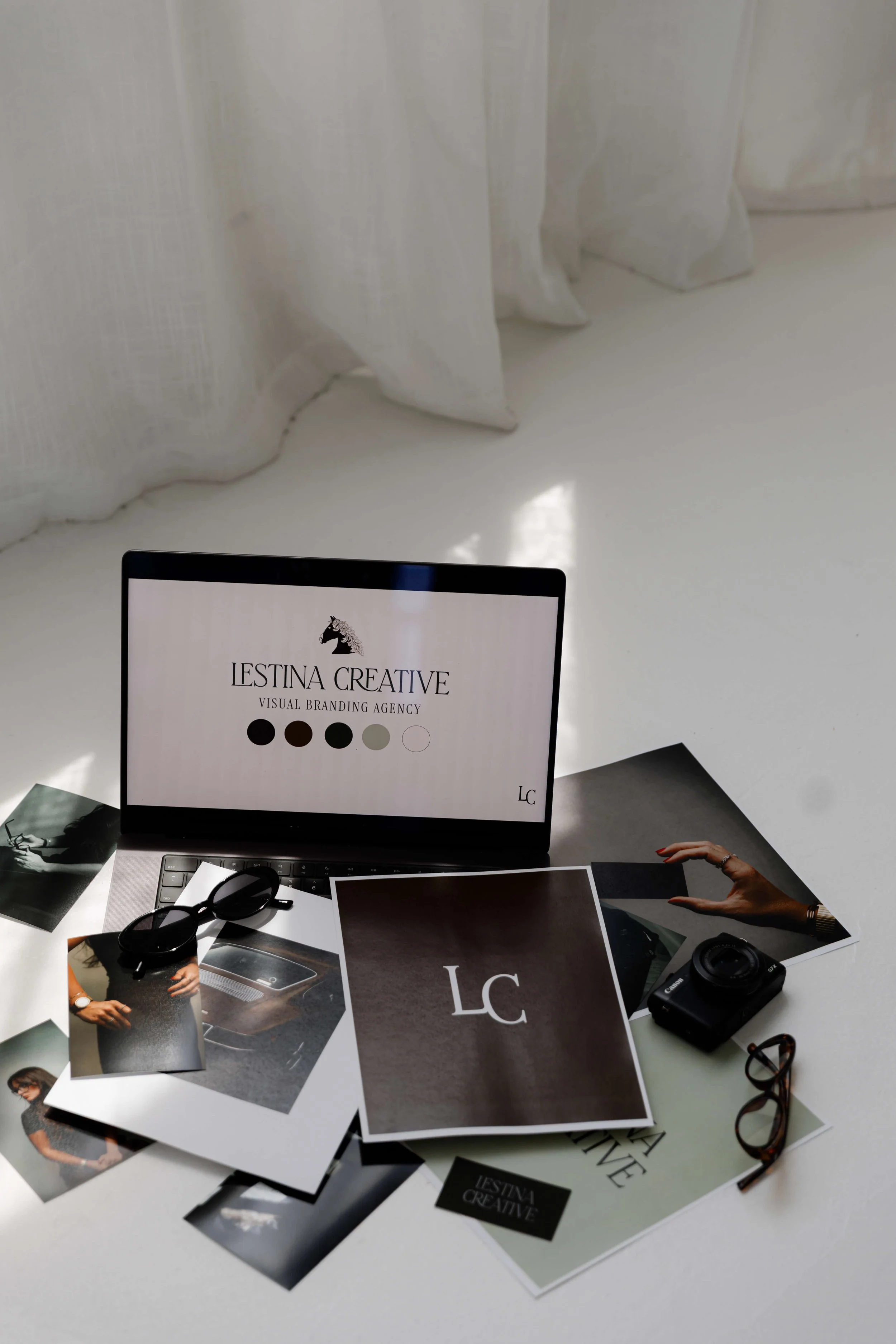A flat lay of brand photos with Lestina Creative branding.