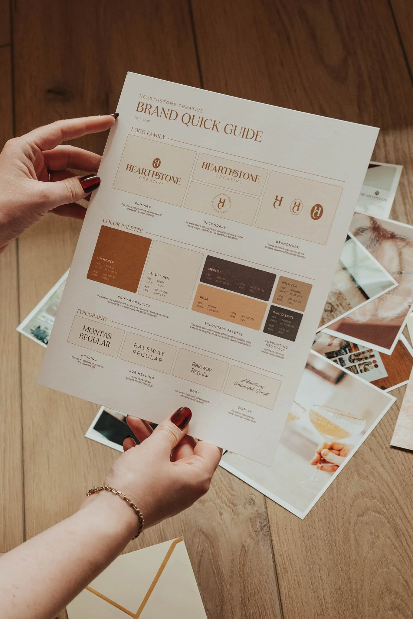 Hands holding a brand quick guide, a one sheet brand guidelines document featured in the brand packages from Hearthstone Creative.