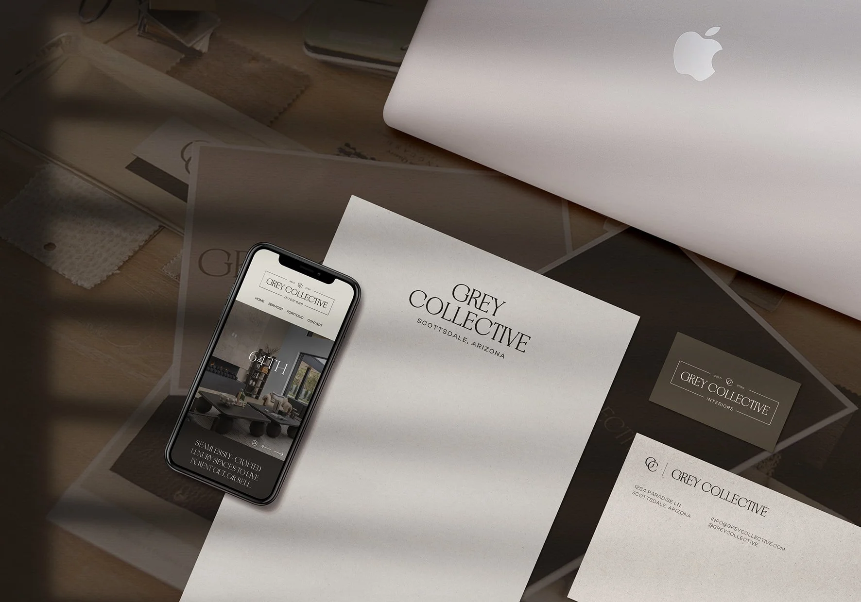 A flay lay of luxury interior designer stationery, website, and business card.