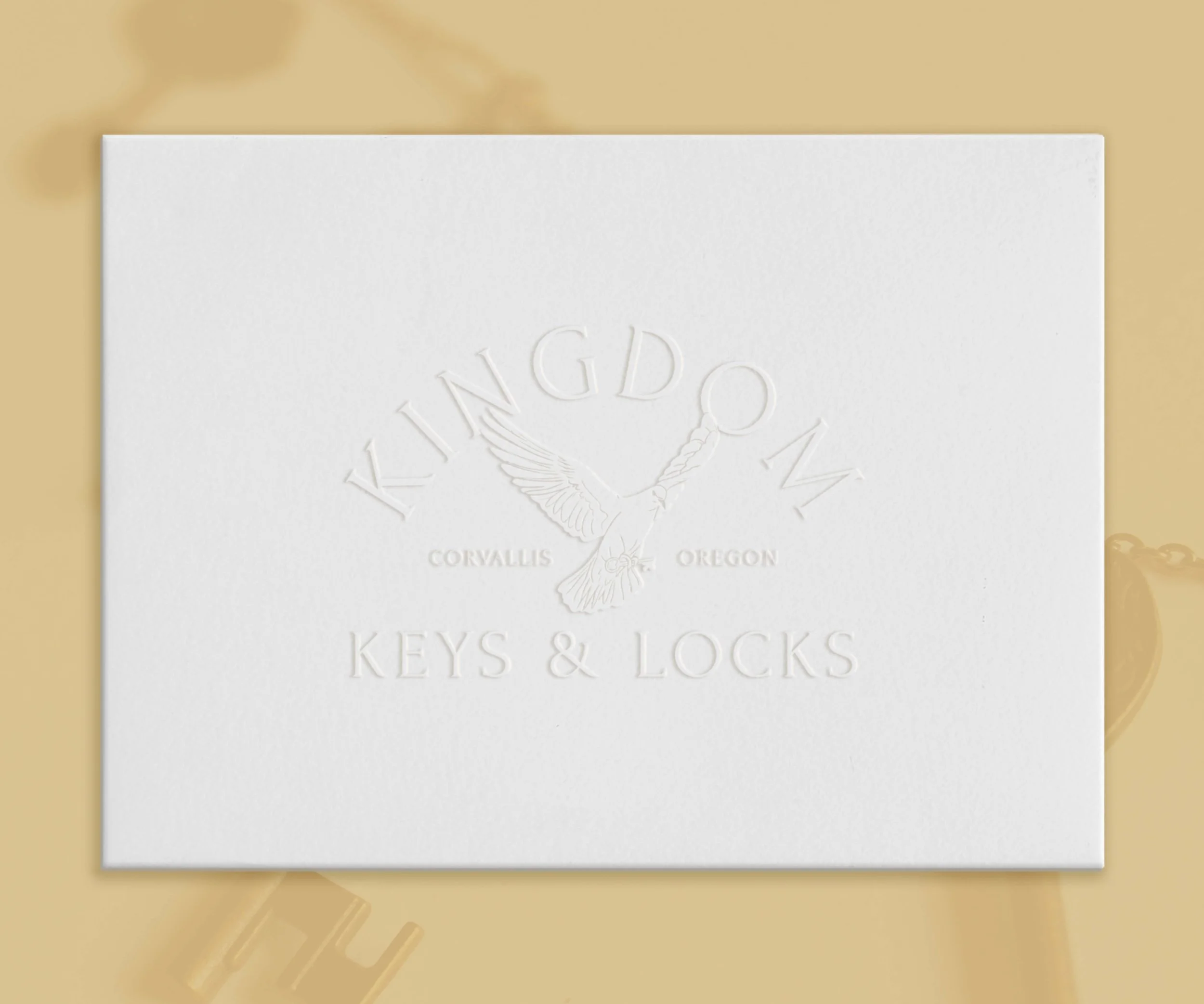 An embossed logo of Kingdom Key's branding is displayed on an envelope.