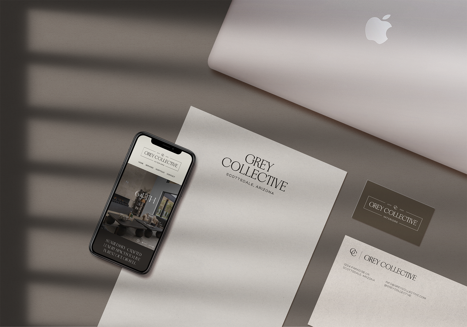 A flat lay of various branded stationery with Grey Collective's logo and branding.