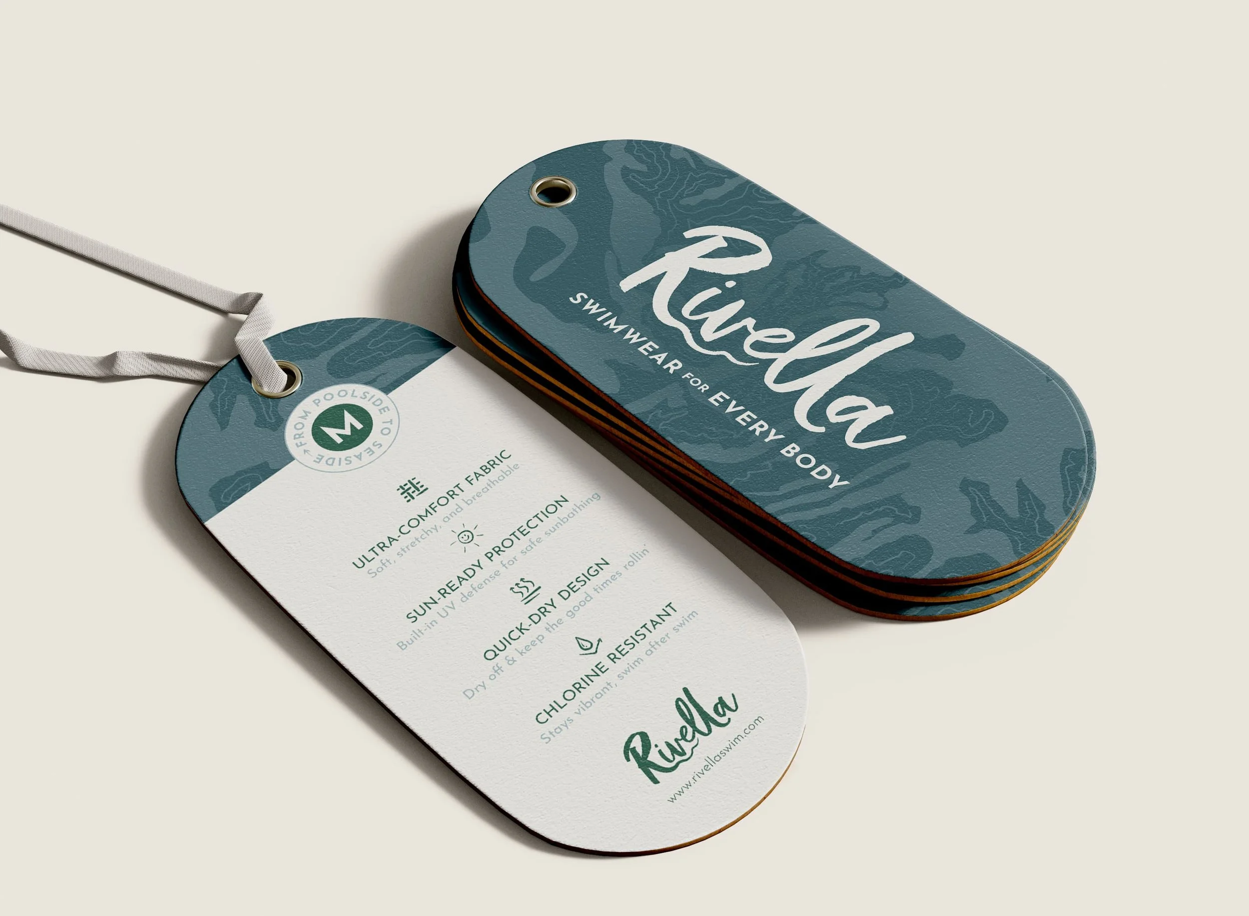 A stack of Rivella swimwear tags with a lanyard, featuring product details such as fabric, protection, design, and durability.
