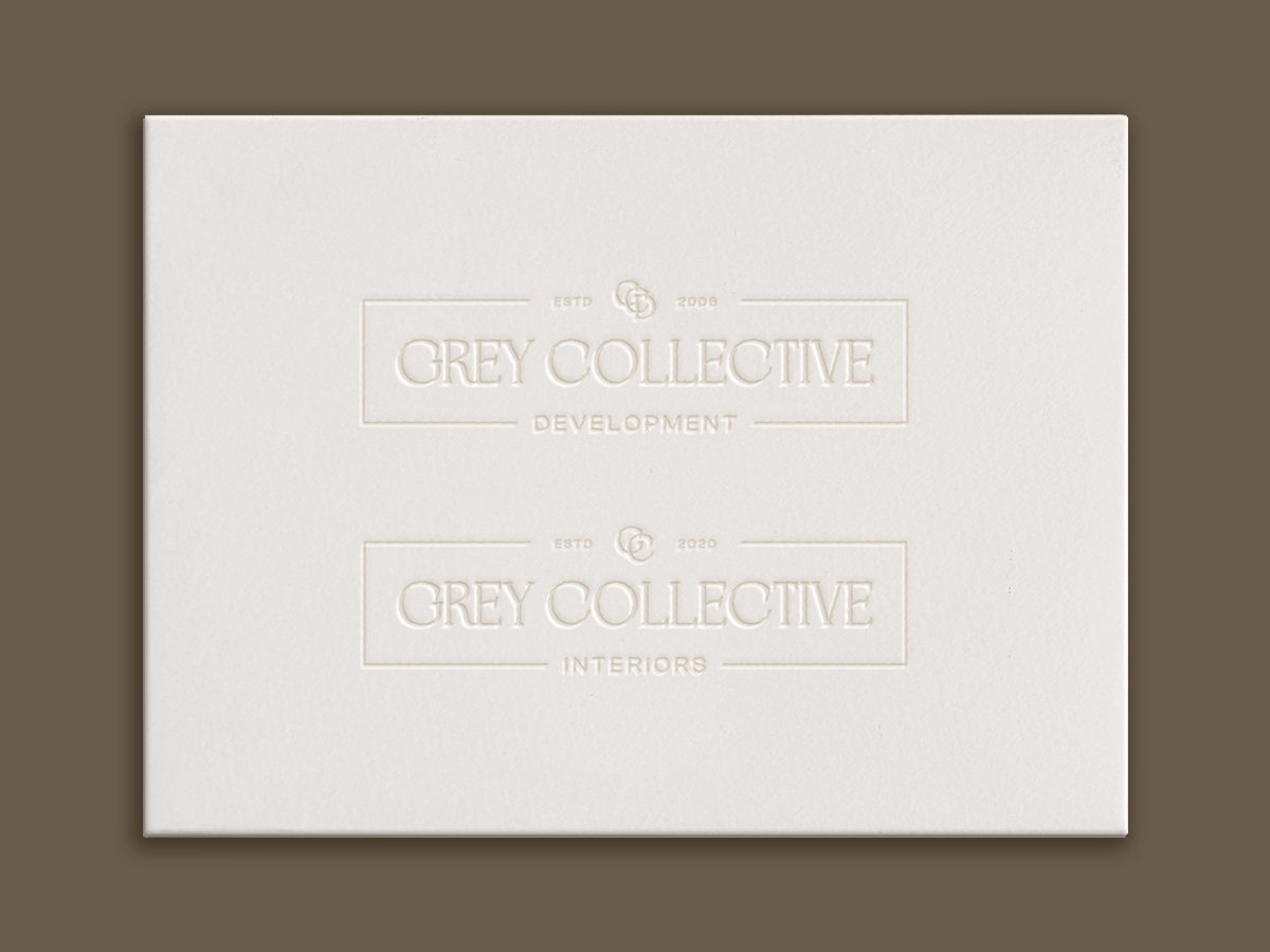 Two logos embossed in an envelope, one for Grey Collective Development, and another for Grey Collective Interiors.