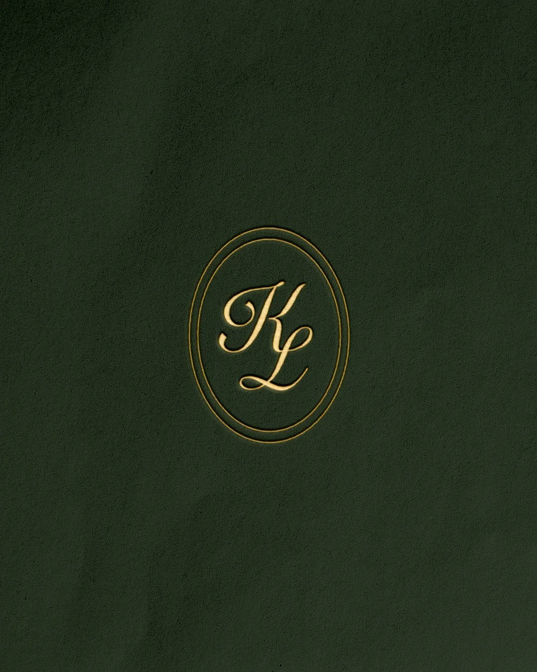 A gold embossed brand mark for Kingdom's branding.