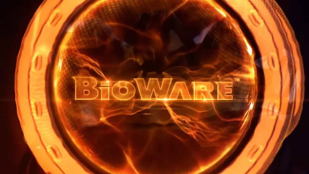 BioWare logo displayed in the intro screen for Mass Effect 3 (2012). Image features a black background and a wavy ring of orange shades surrounding the studio's name in capital block letters.