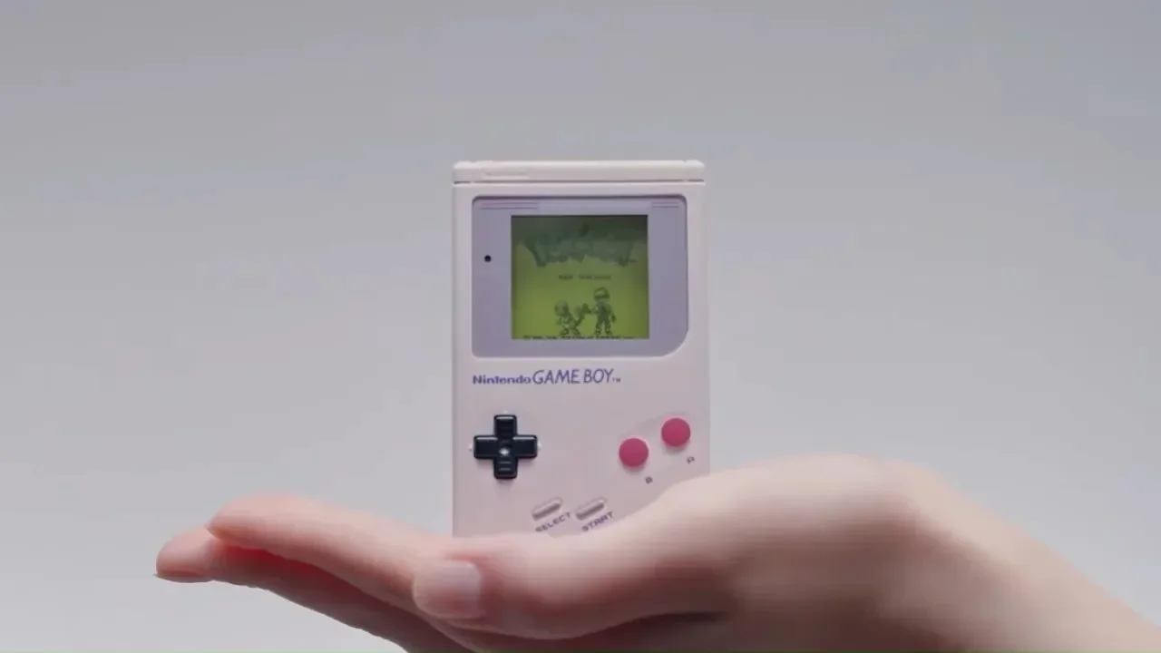 A picture of the GameBoy-inspired jukebox being held in the palm of someone’s hand