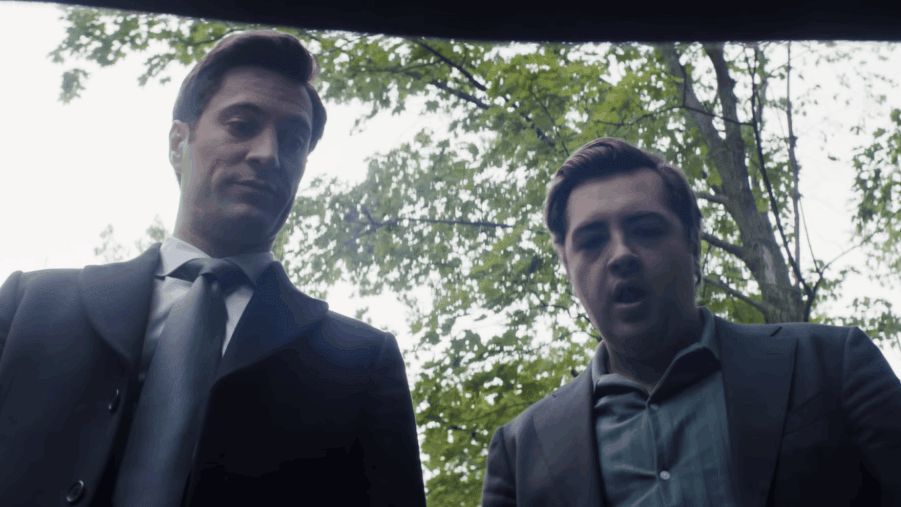 Buck Cashman and Daniel Blake look down at something