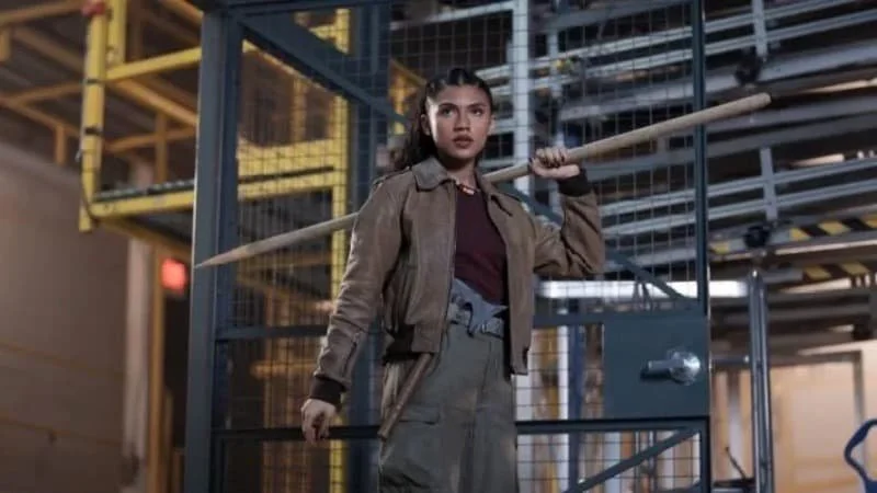 Clarisse holds her spear triumphantly