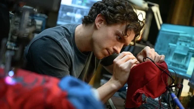 Peter Parker working on his suit   Image Source: TheWrap