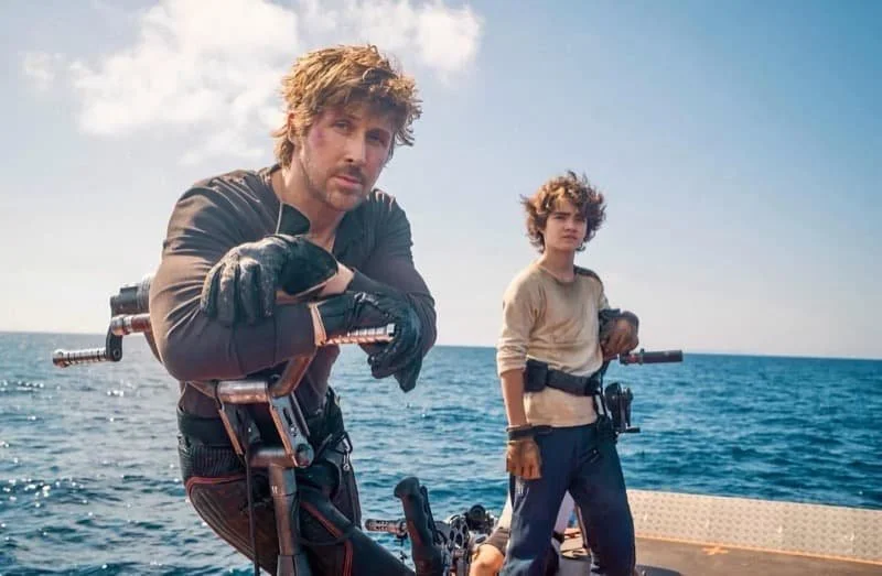 Ryan Gosling and Flynn Gray stood as their characters while out over the sea.