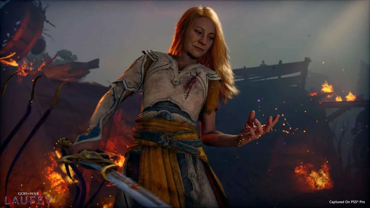 Promotional image for God of War Laufey featuring the titular character holding a sword and looking down to her empty hand, surrounded by patches of fire