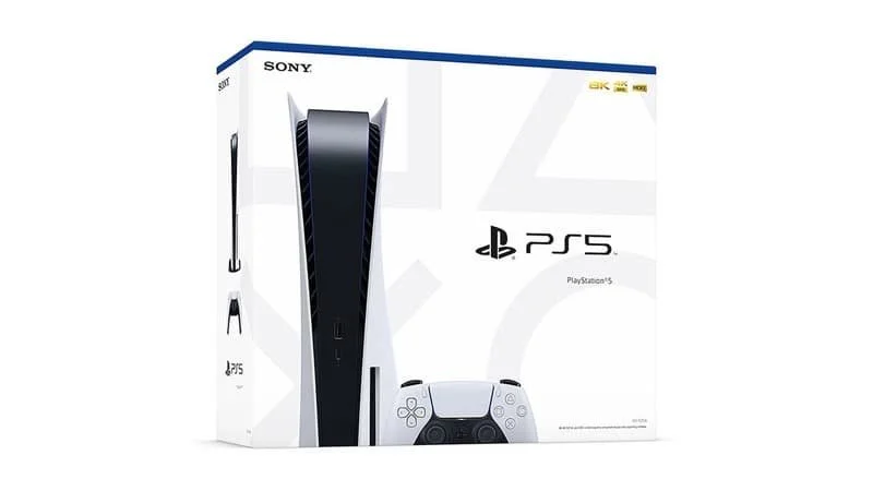 Disc drive edition of the PlayStation 5 in its box against a white background, console and one DualSense controller featured.   Image Source: PlayStation Wiki