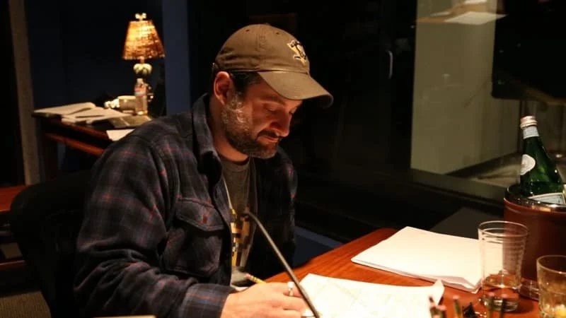 Dave Filoni is in an office, drawing ideas on paper