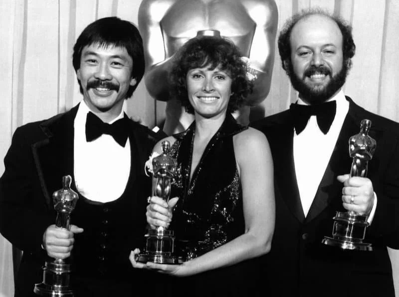 Image description: Richard Chew, Marcia Lucas, and Paul Hirsch at the Oscars