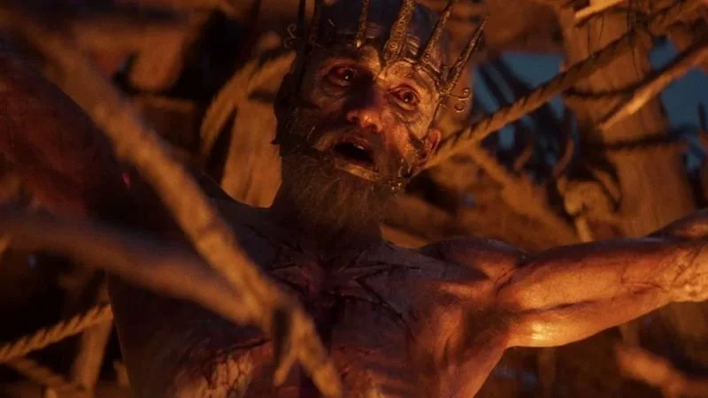 A man strung up, waiting to be sacrificed