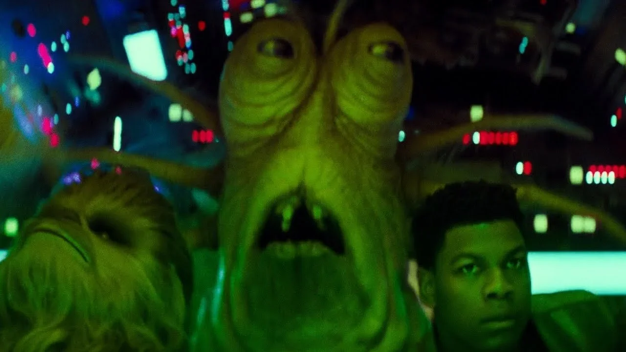 Klaud in the Millenium Falcon cockpit with Finn and Chewbacca.