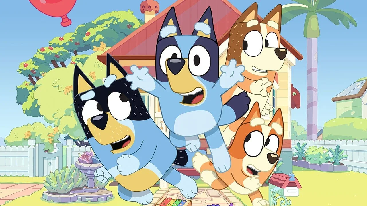 Bluey, Bandit, Bingo, and Chili Heller lunging toward a balloon in a game of Keepy Uppy outside the Heeler family home