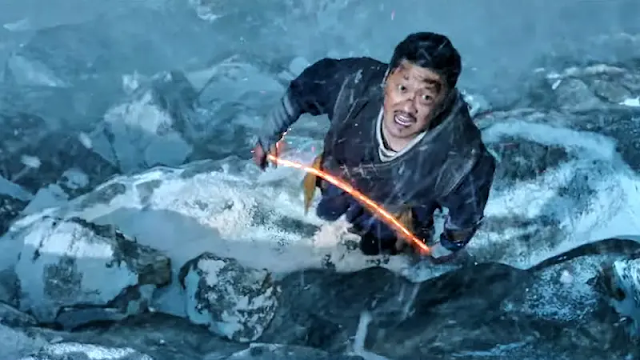 Wong On The Ledge Of A Snowy Mountain