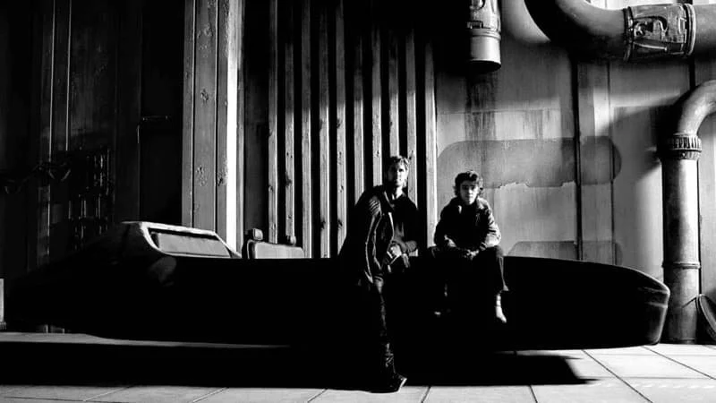 black and white promotional image for Star Wars: Starfighter, on which Kennedy is a producer. Ryan Gosling and Flynn Gray are sitting on a speeder with an industrial background