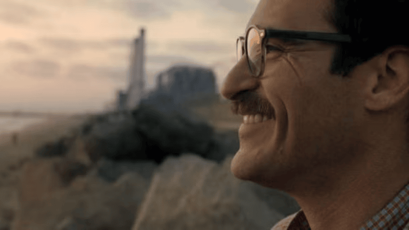 Image Description: Joaquin Phoenix smiling out over a landscape