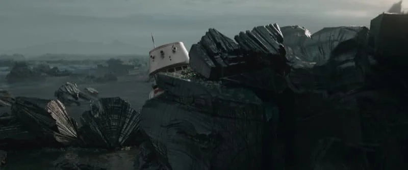 The blasted wasteland that is the surface of Mandalore, with R5-D4 peering out over the crags