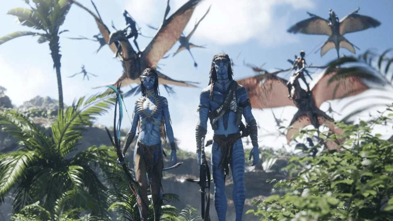 Neytiri and Sully walking in battle gear, members of the Metkayina clan rising into the air behind them