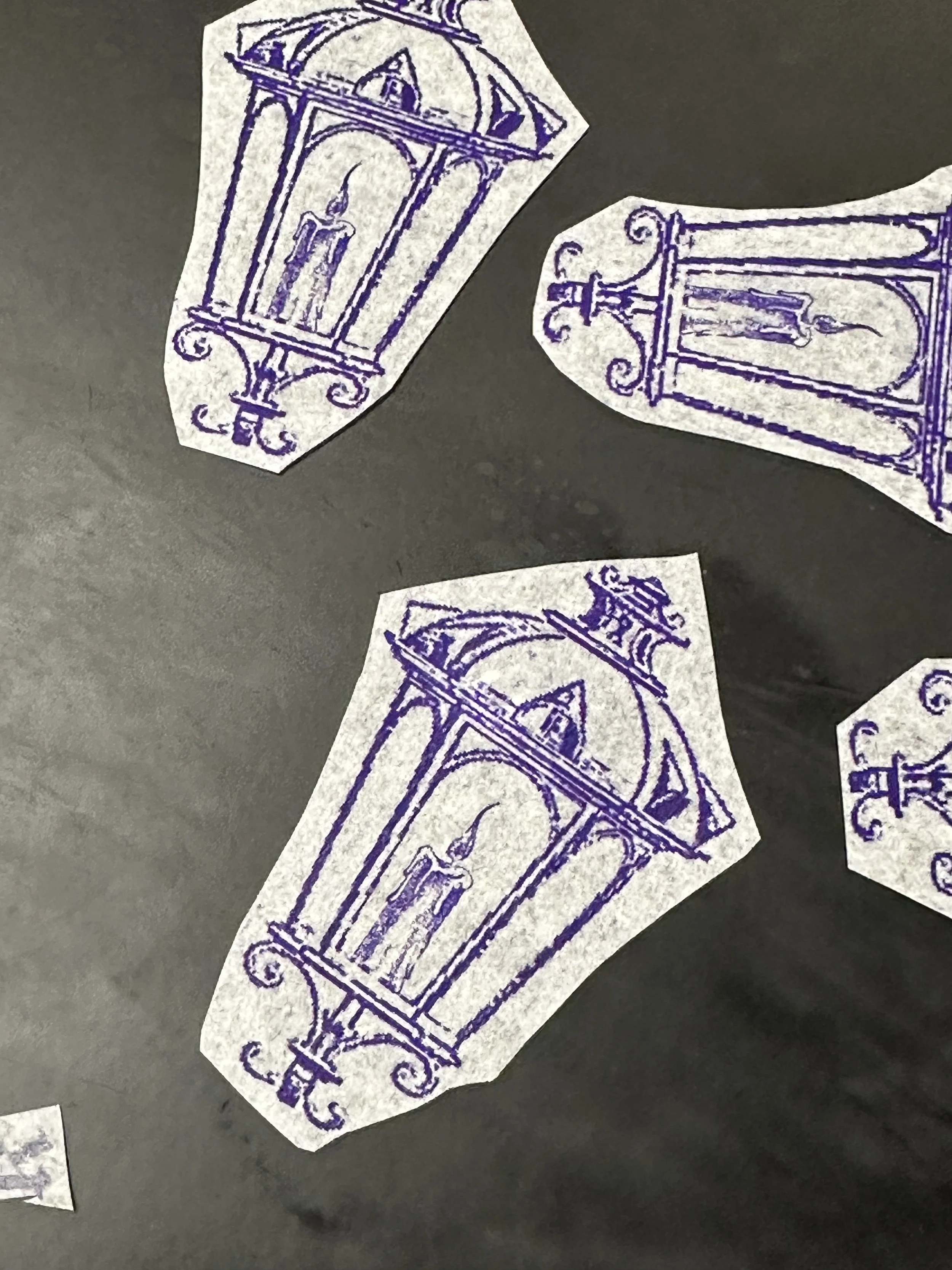 Photo of purple line-drawn lantern tattoo designs on a dark background, overlaid with a white quote card that reads, "It is the light in the lantern which shows you the path, not the lantern." with attribution ‘A Yogi Tea Quote.’.