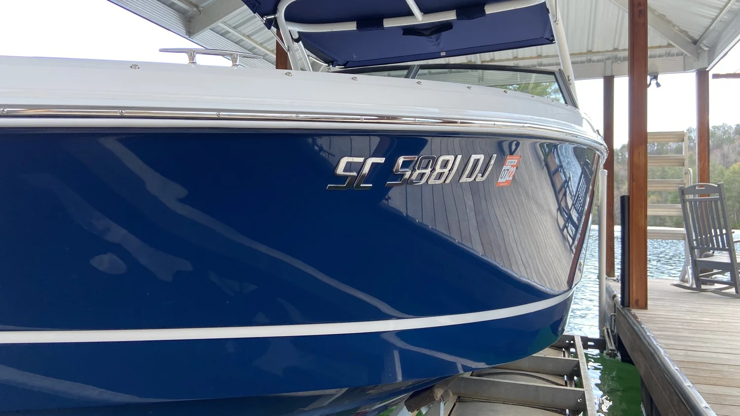 Corrected and ceramic coated gelcoat on a blue Cobalt hull at Lake Keowee — deep reflection, no chalking