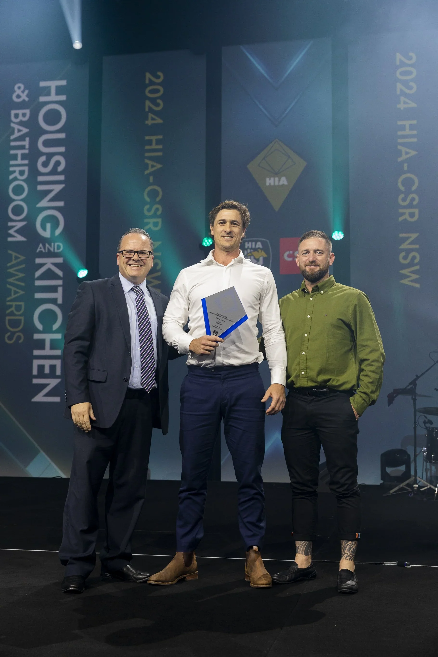 Grant Kerrigan and Taylor Melbin of TAG Homes accepting the 2024 HIA NSW Region Start-up Business Award on stage