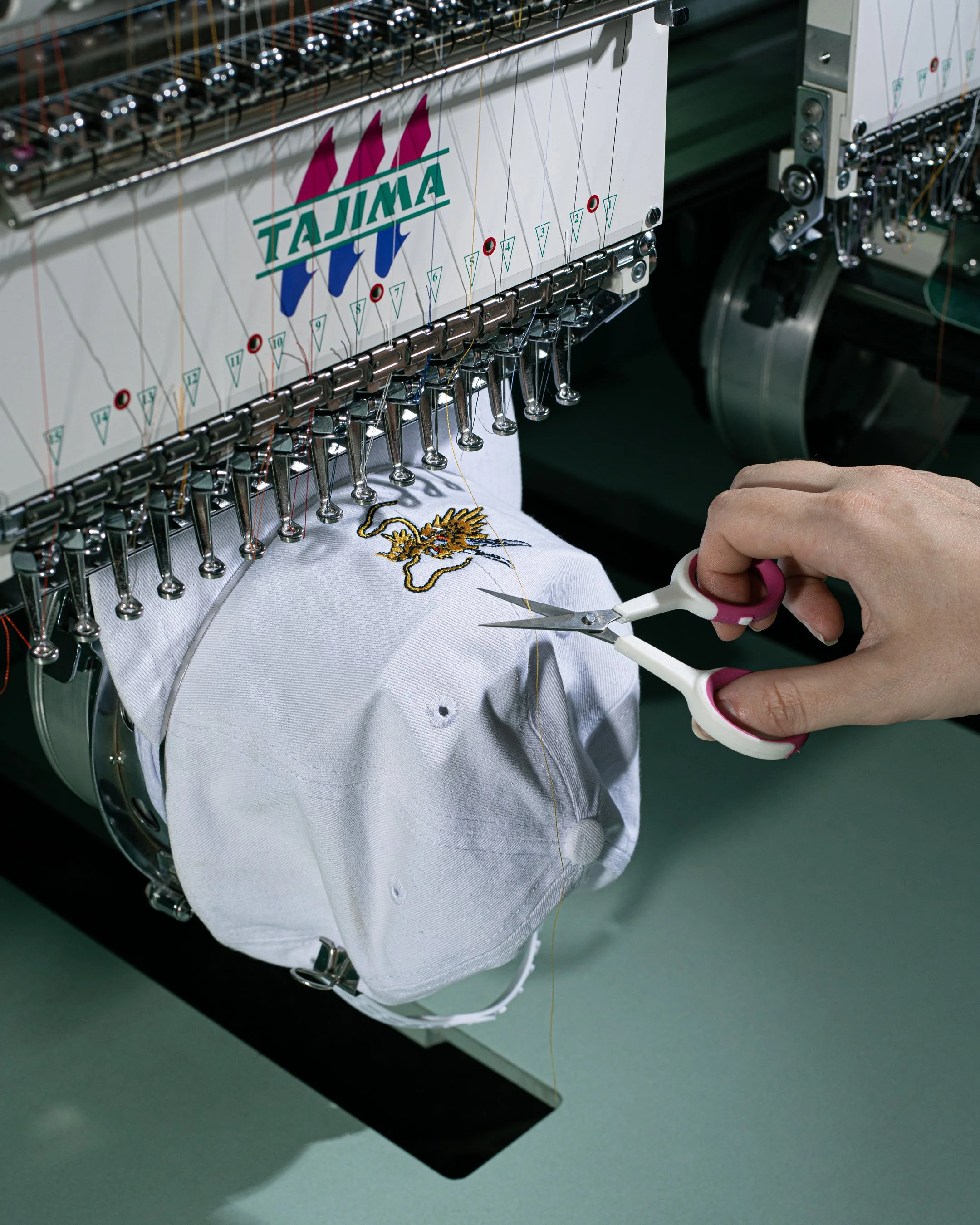 Custom merchandise hat being embroidered
