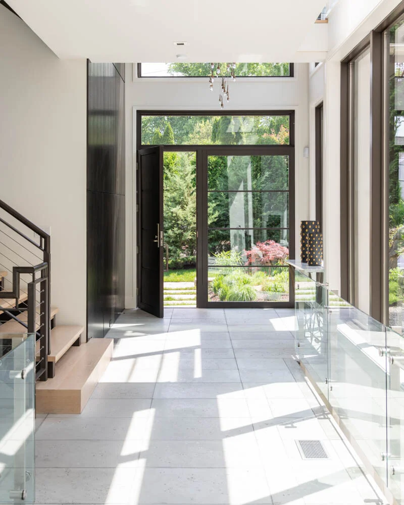 view from hallway through entry door towards gardens