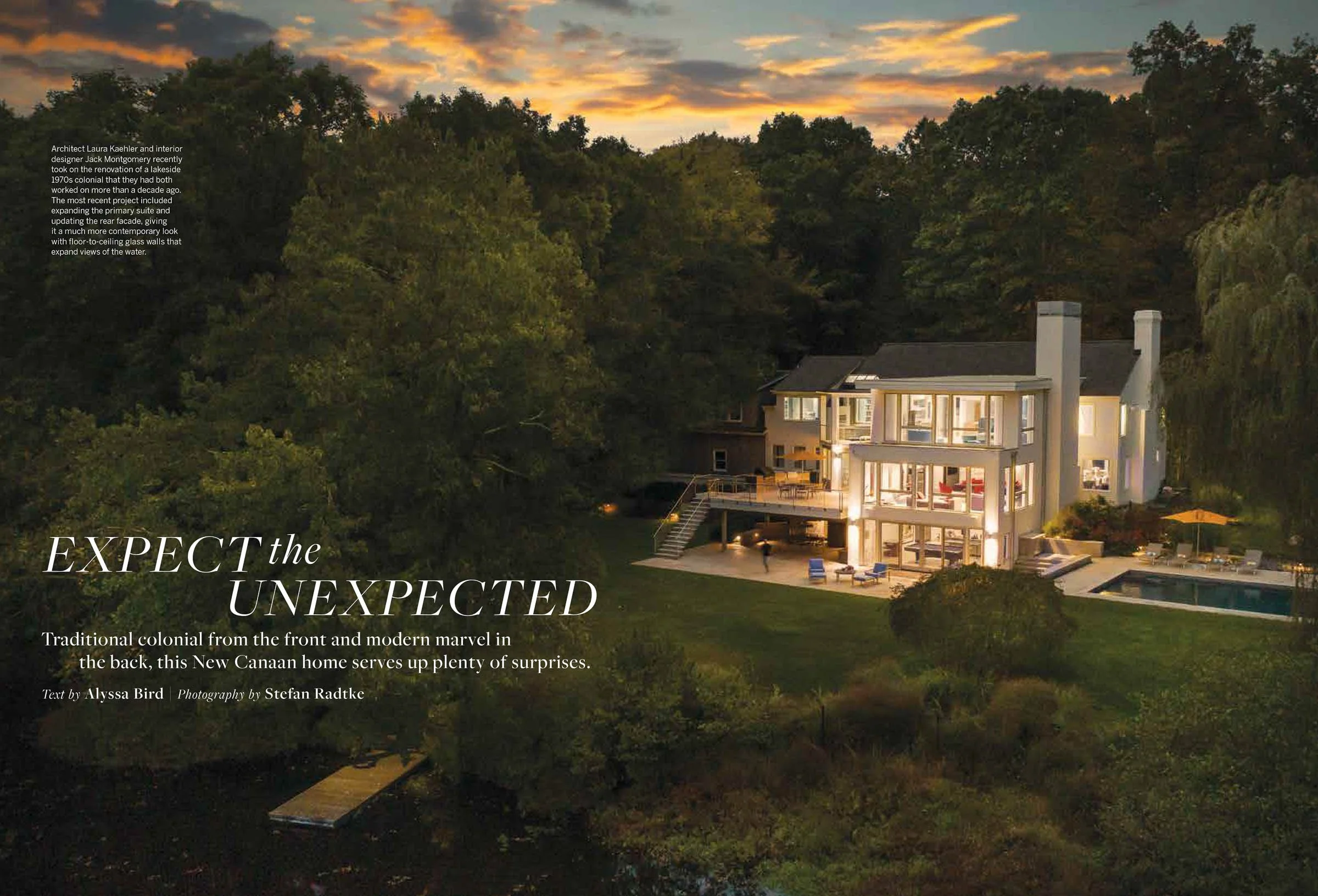 A modern, illuminated house at dusk surrounded by trees, featuring large windows and a deck. The sky is vibrant with a sunset. Text includes "EXPECT the UNEXPECTED" and describes a New Canaan home blending colonial and modern styles.