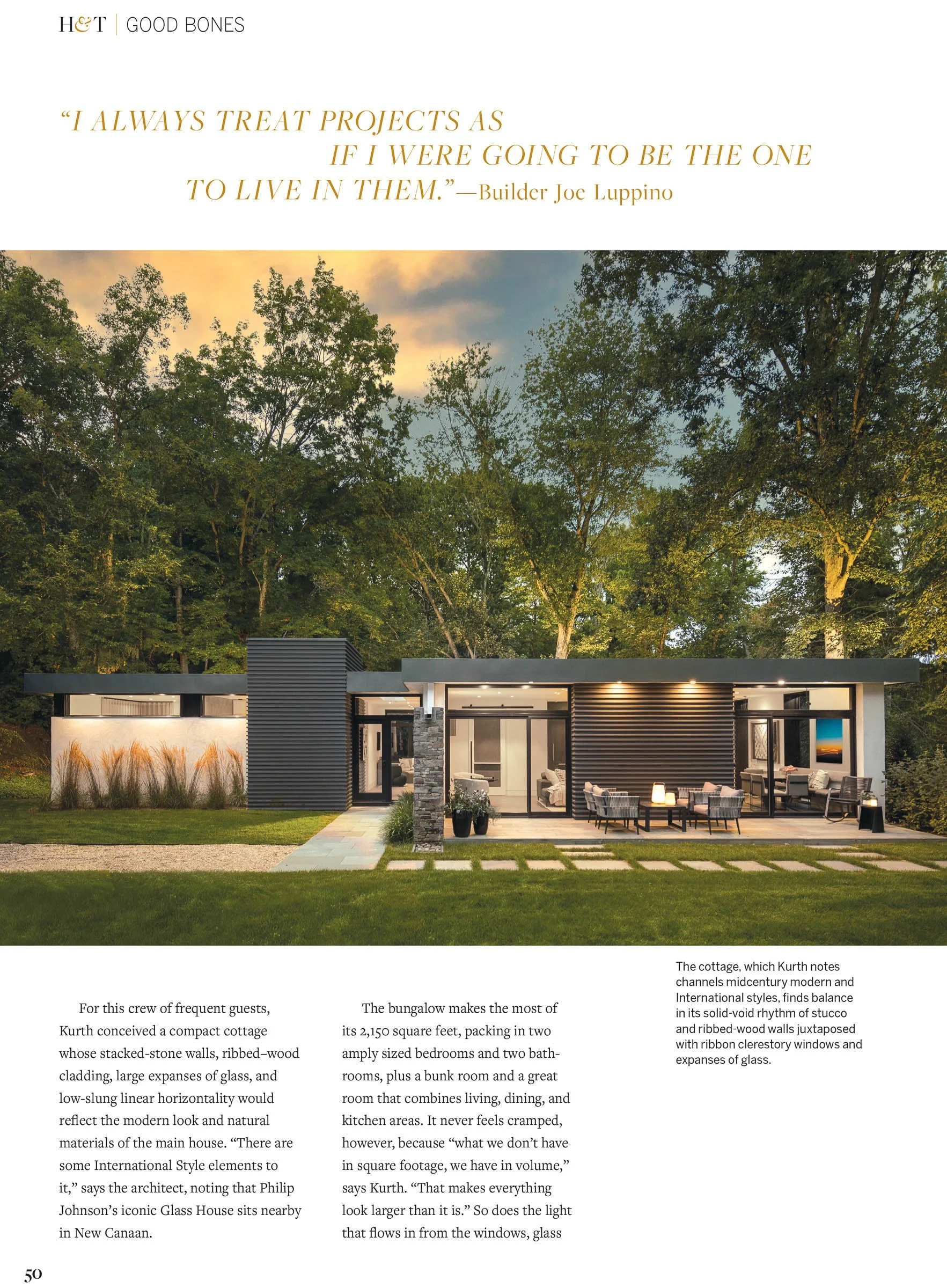 Modern bungalow surrounded by trees at sunset, featuring ribbed-wood cladding, large windows, and a patio with outdoor seating.