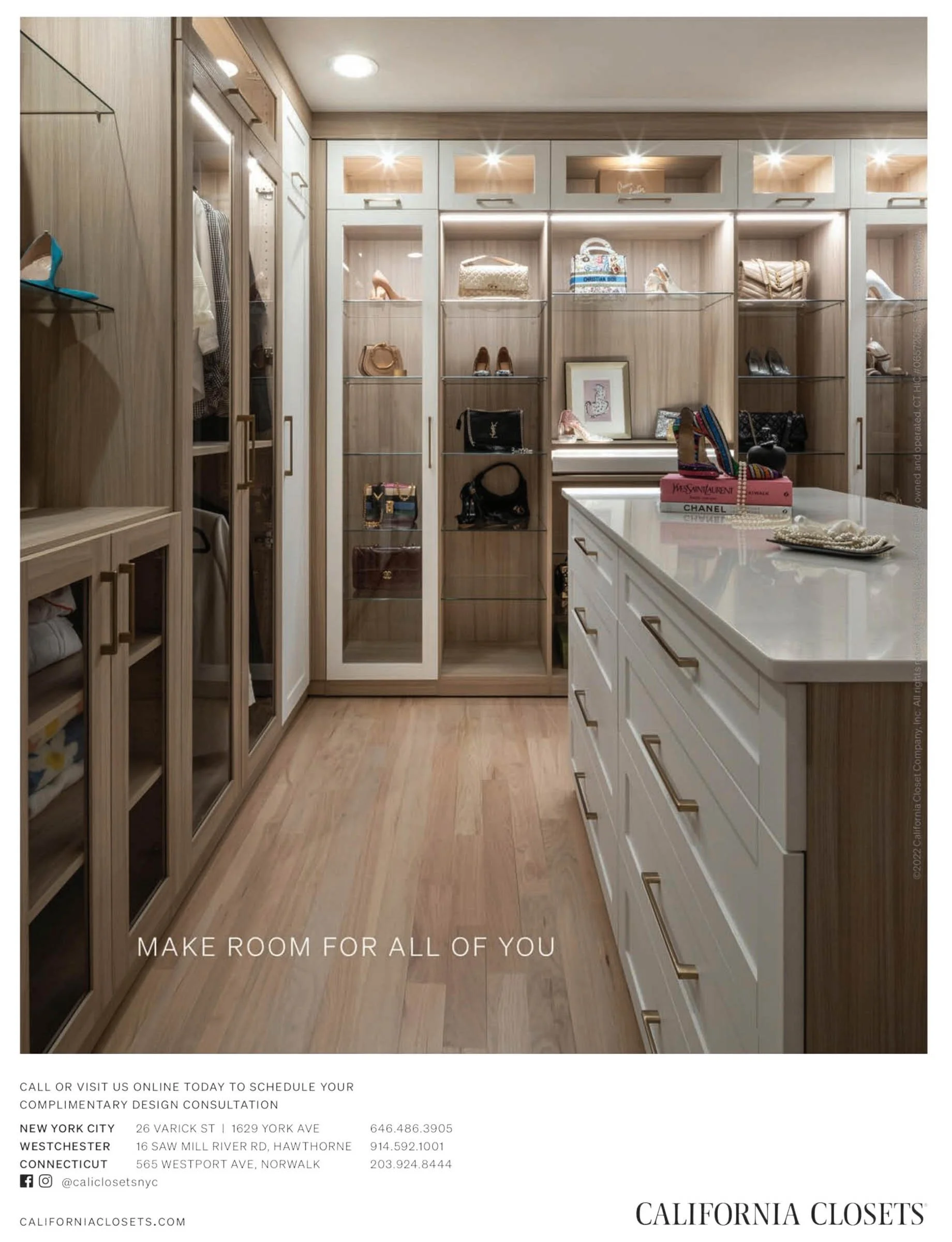 Modern walk-in closet with wooden shelves, glass display cases, handbags, and shoes. White drawers with gold handles. Overhead lighting highlights luxury items. California Closets branding and contact details at bottom.